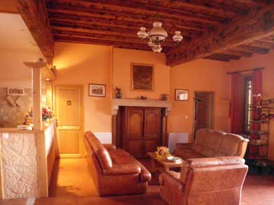 Living room with leather sofas and DVD player in old cabinet.